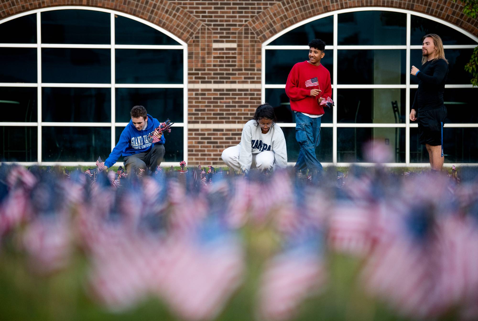 Several Student Senators putting up flags in the Kirkhof lawn as a memorial for the 9/11 attacks.